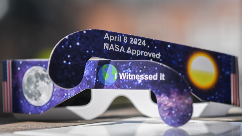 A pair of 'NASA-approved' Solar Eclipse glasses are shown in Montreal, Tuesday, April 2, 2024. There have been many counterfeit glasses that have appeared on the market in recent months. NASA does not approve any glasses. (Graham Hughes, The Canadian Press)