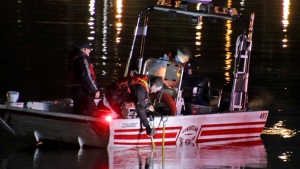 Firefighters are seen on a rescue boat in the Fraser River after a car became submerged on April 6, 2024. 
