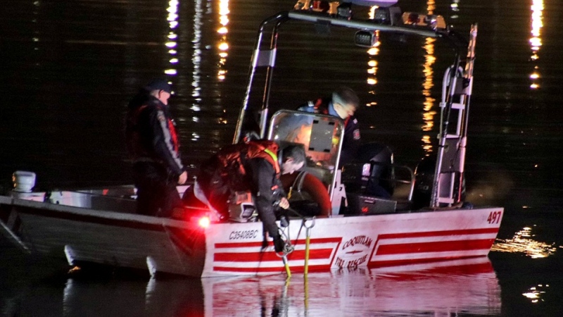 Firefighters are seen on a rescue boat in the Fraser River after a car became submerged on April 6, 2024. 