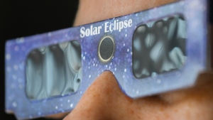 A person wears a pair of NASA-approved solar eclipse glasses in Montreal, Tuesday, April 2, 2024. THE CANADIAN PRESS/Graham Hughes