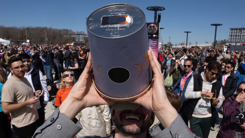 People watch the solar eclipse at Parc Jean Drapeau in Montreal on Monday, April 8, 2024. (Ryan Remiorz / The Canadian Press)