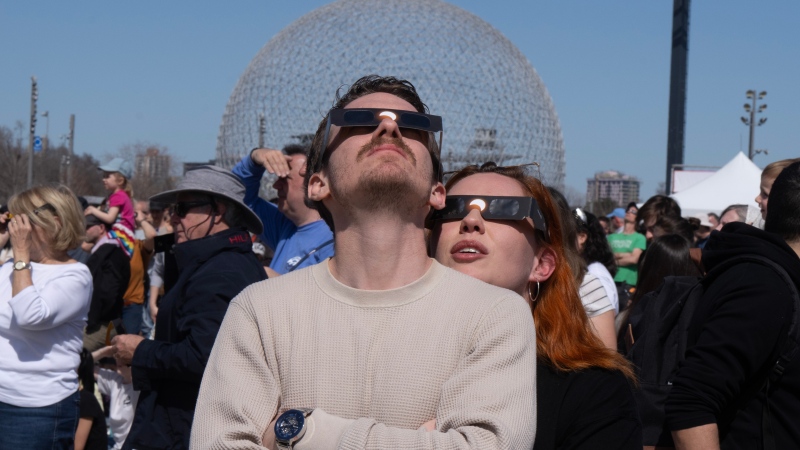 People watch the solar eclipse at Parc Jean Drapeau, in Montreal, Monday, April 8, 2024. (Ryan Remiorz / The Canadian Press)
