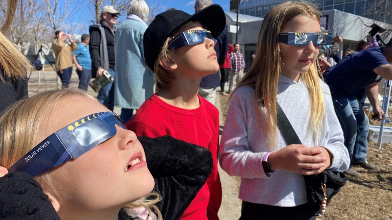 Children wearing protective eyeglasses marvel at the partial solar eclipse at the Saskatchewan Science Centre on April 8, 2024. (Gareth Dillistone/CTV News)