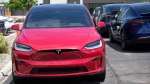 Unsold 2023 Model X sports-utility vehicles sit in a long row at a Tesla dealership Sunday, June 18, 2023, in Littleton, Colo. (AP Photo/David Zalubowski)