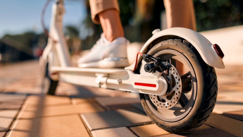 A person rides an e-scooter in this undated stock image. (Shutterstock)