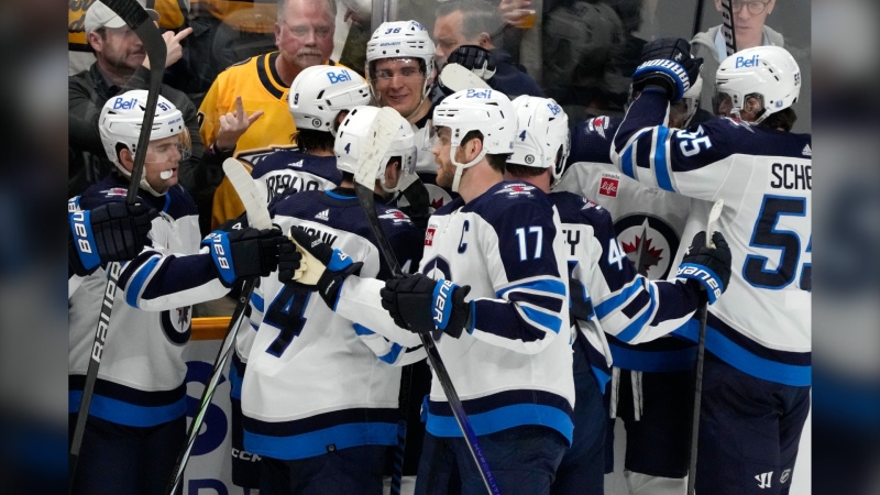 The Winnipeg Jets celebrate after defeating the Nashville Predators in overtime in an NHL hockey game Tuesday, April 9, 2024, in Nashville, Tenn. (AP Photo/Mark Humphrey)
