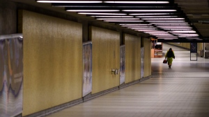 A lone commuter walks a tunnel leading to the metro in Montreal, on Wednesday, Oct. 14, 2020. (Paul Chiasson/The Canadian Press)