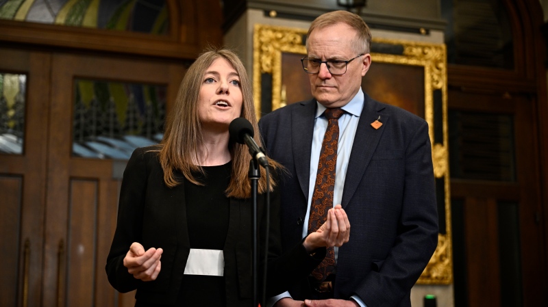 NDP MPs Laurel Collins and Peter Julian speak in the Foyer of the House of Commons before Question Period, on Parliament Hill in Ottawa on Wednesday, April 10, 2024. THE CANADIAN PRESS/Justin Tang