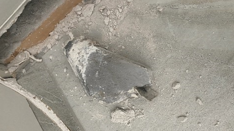 A metal object that fell through the roof of a Kitchener, Ont. home on April 8, 2024. (Submitted)