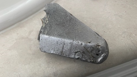 A metal object that fell through the roof of a Kitchener, Ont. home on April 8, 2024. (Submitted)