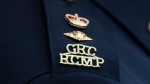 The RCMP logo is seen on the shoulder of a superintendent during a news conference. (Source: THE CANADIAN PRESS/Adrian Wyld)