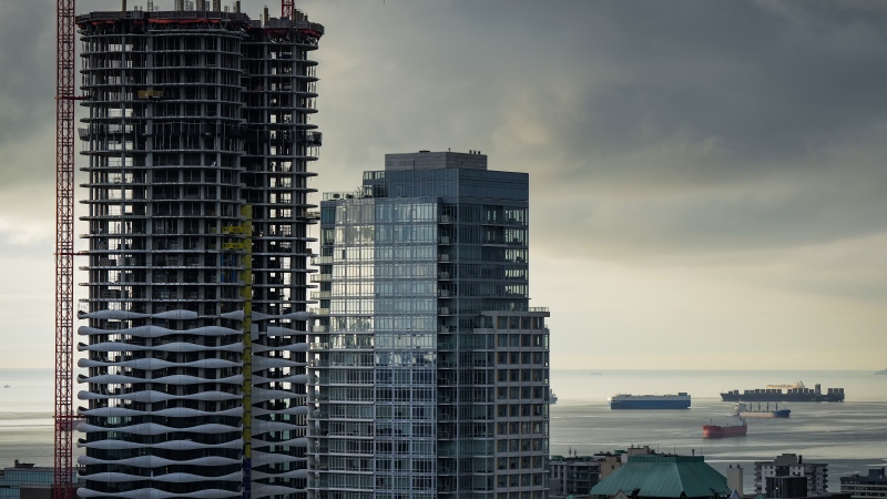 A condo tower is seen under construction in downtown Vancouver as freighters sit at anchor on English Bay, on Thursday, January 19, 2023. THE CANADIAN PRESS/Darryl Dyck