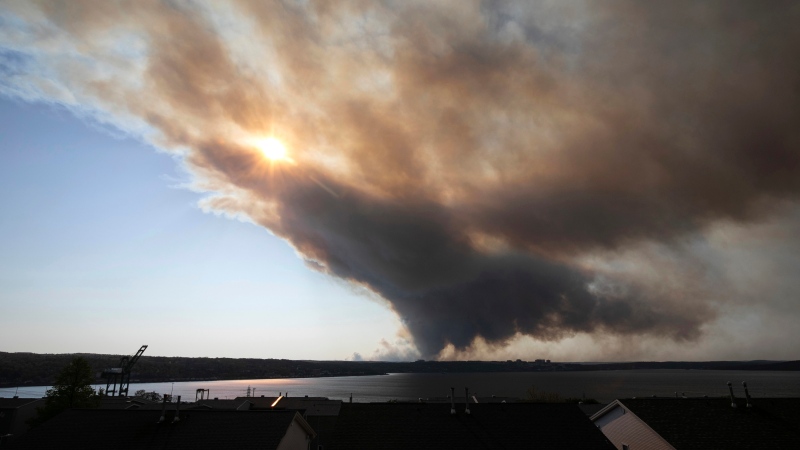Thick plumes of heavy smoke fill the Halifax sky as an out-of-control fire in a suburban community quickly spread, engulfing multiple homes and forcing the evacuation of local residents, in Halifax, Nova Scotia, on Sunday May 28, 2023. (Source: Kelly Clark/The Canadian Press via AP)