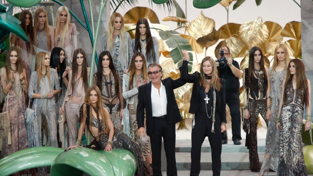 Roberto Cavalli and his wife Eva Duringer receive their share of applause at the end of their Spring-Summer 2011 fashion collection, during the fashion week in Milan, Italy, Monday, Sept. 27, 2010. (AP Photo/Antonio Calanni)
