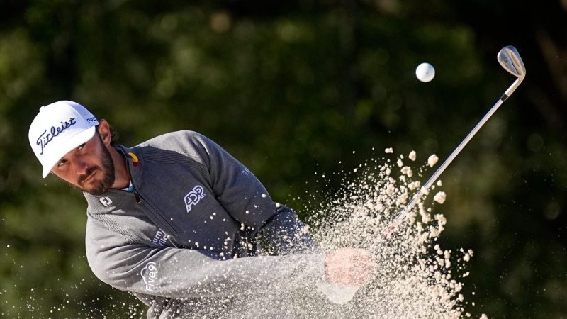 Max Homa hits from the bunker on the 18th hole during the weather delayed first round at the Masters golf tournament at Augusta National Golf Club, April 12, 2024, in Augusta, Ga. (AP Photo/George Walker IV)