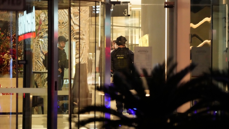 Police officers stand guard inside Westfield Shopping Centre, where multiple people were stabbed in Sydney, Saturday, April 13, 2024. Five people and a suspect were killed in a Sydney shopping center stabbing attack on Saturday that left multiple people, including a small child, injured, police said. (AP Photo/Rick Rycroft)