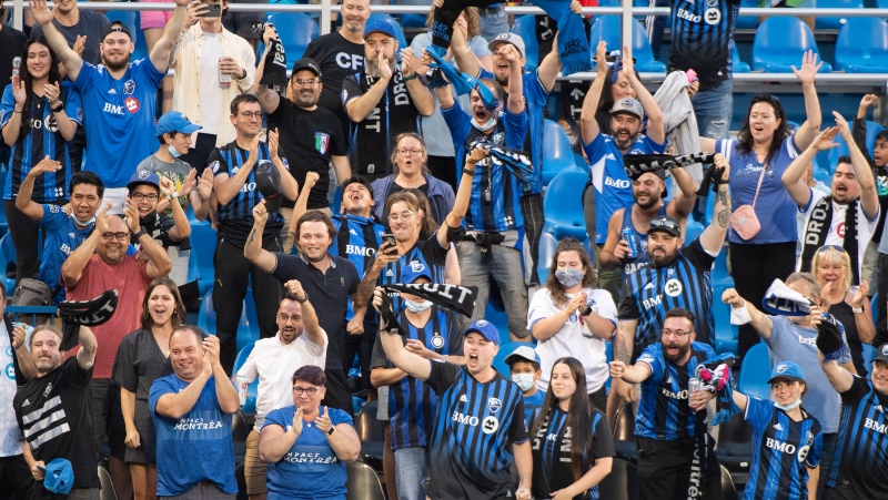 CF Montreal fans celebrate a goal during first half MLS soccer action against FC Cincinnati in Montreal, Saturday, July 17, 2021. (Graham Hughes, The Canadian Press)