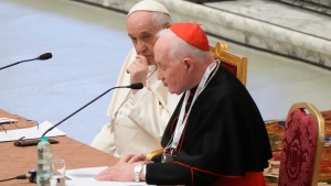 Pope Francis, left, listens to Cardinal Marc Ouellet's opening address as he attends the opening of a 3-day Symposium on Vocations in the Paul VI hall at the Vatican, Thursday, Feb. 17, 2022. (Gregorio Borgia, The Associated Press)