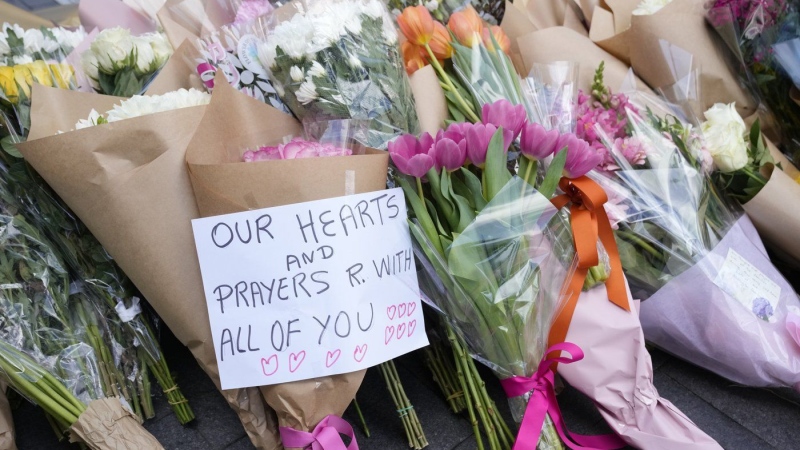 A note is left with flower tributes near a crime scene at Bondi Junction in Sydney, Sunday, April 14, 2024. (Rick Rycroft/AP Photo)