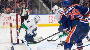 Vancouver Canucks' goalie Casey DeSmith (29) makes the save on Edmonton Oilers' Leon Draisaitl (29) during second period NHL action in Edmonton, Saturday, April 13, 2024. THE CANADIAN PRESS/Jason Franson