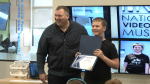 Kenny Parkes (right) celebrates winning the Code Ninjas Prodigy Program with Barrie Mayor Alex Nuttall (left) at Code Ninjas in Barrie on April 13, 2024 (Steve Mann/CTV News). 