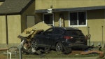 An SUV crashed into two townhomes in northeast Edmonton on April 14, 2024. (Marek Tkach/CTV News Edmonton)