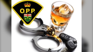 Ontario Provincial Police arrested an Elliot Lake man for refusing to provide a breath sample after leaving a local bar on April 11, 2024. A pair of handcuffs, an alcoholic beverage with an Ontario Provincial Police crest. (File photo/Supplied/Ontario Provincial Police)