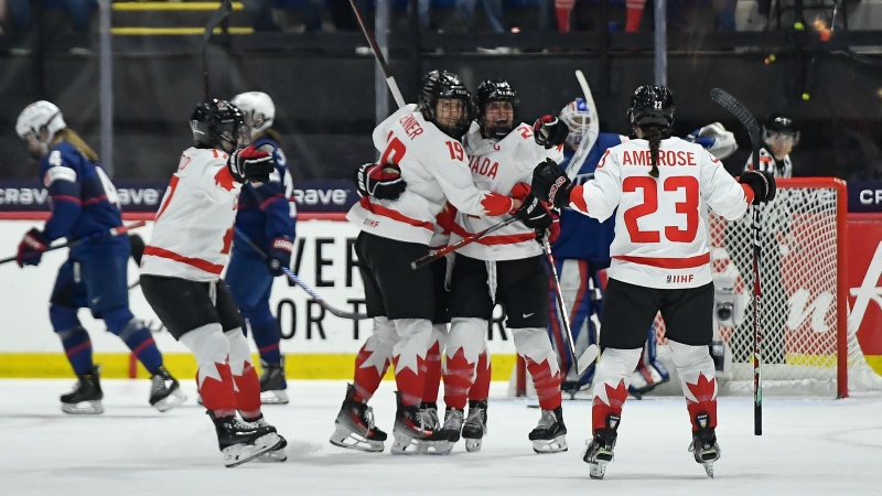Canada defencewoman Erin Ambrose (23) celebrates with forwards Marie-Philip Poulin, second from right, and Brianne Jenner (19) after scoring during the first period in the final against the U.S. at the IIHF Women's World Hockey Championships on April 14, 2024. (AP Photo/Adrian Kraus)