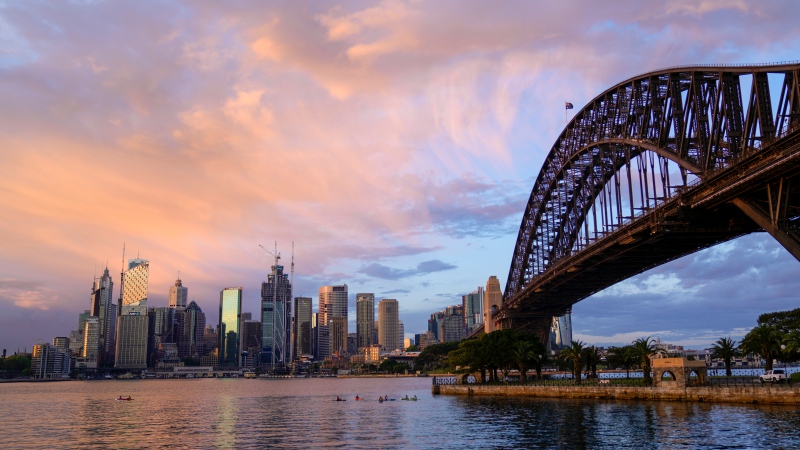 The sun rises over the skyline of central business district of Sydney, Tuesday, Oct. 19, 2021. (AP Photo/Mark Baker)