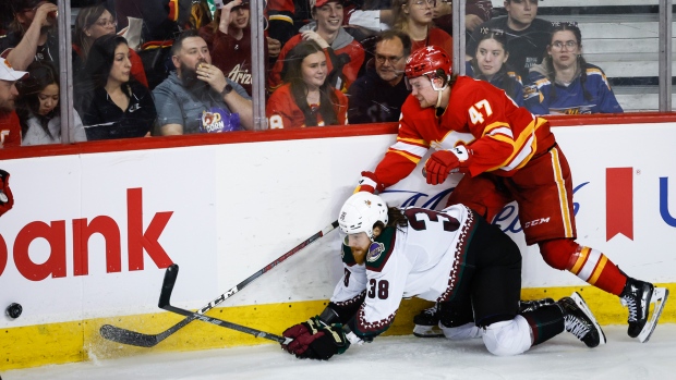 Arizona Coyotes forward Liam O'Brien (38) is checked by Calgary Flames forward Connor Zary (47) during third period NHL hockey action in Calgary, Alta., Sunday, April 14, 2024. THE CANADIAN PRESS/Jeff McIntosh