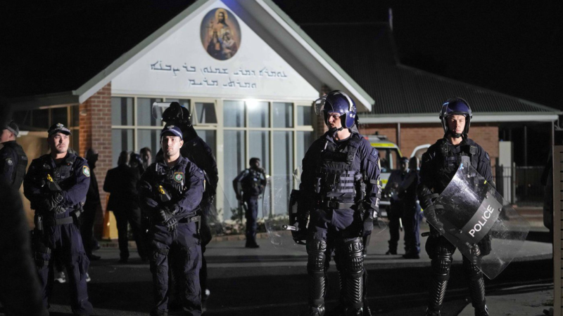 Security officers stand guard outside Orthodox Assyrian church in Sydney, Australia, Monday, April 15, 2024. (AP Photo/Mark Baker)