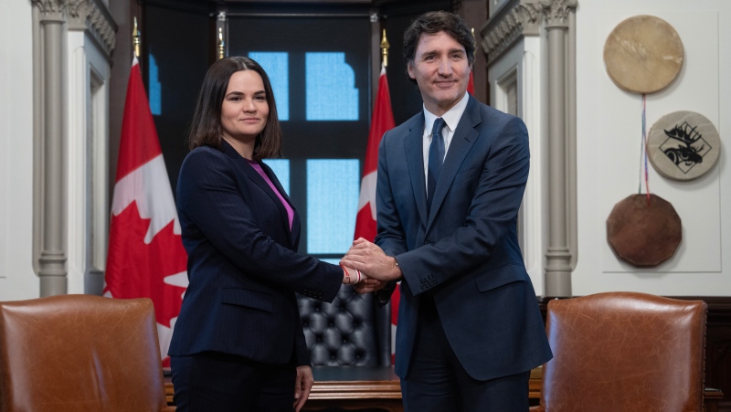 Prime Minister Justin Trudeau and Belarus opposition leader Sviatlana Tsikhanouskaya pose for cameras as they shake hands before a meeting, Monday, April 15, 2024 in Ottawa. THE CANADIAN PRESS/Adrian Wyld