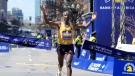 Sisay Lemma, of Ethiopia, breaks the tape to win the Boston Marathon, Monday, April 15, 2024, in Boston. (AP Photo/Steven Senne)
