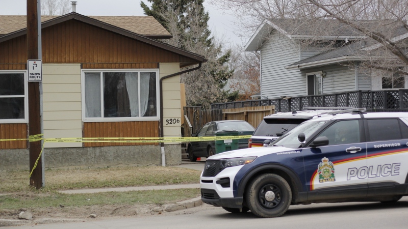 Police cruisers parked outside of the 33rd Street home where officers found the body of a woman on April 15, 2024. (Rory MacLean / CTV News)