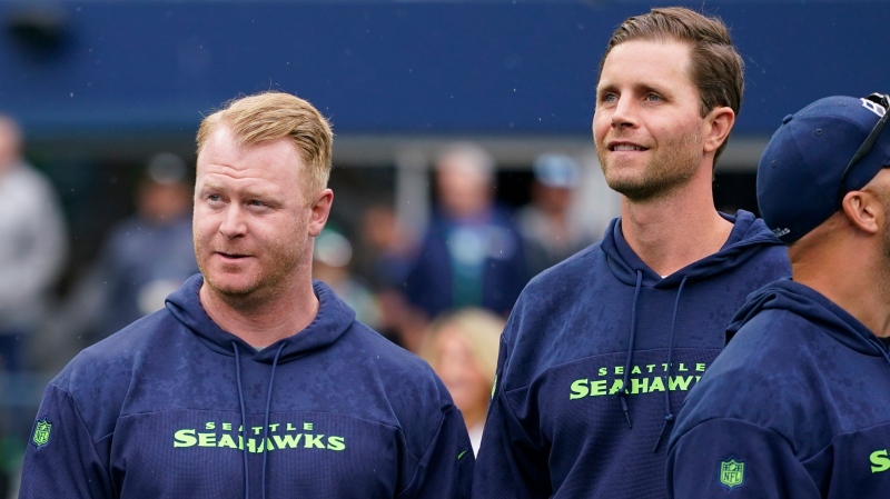 Former Seattle Seahawks punter Jon Ryan, left, and former place-kicker Stephen Hauschka, right, look on as members of the Super Bowl XLVIII-winning team gather for a 10-year anniversary celebration during halftime of an NFL football game against the Carolina Panthers, Sunday, Sept. 24, 2023, in Seattle. The Seahawks won 37-27. (AP Photo/Lindsey Wasson)