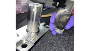 This undated photo provided by NASA shows a recovered chunk of space junk from equipment discarded at the International Space Station. (NASA via AP)