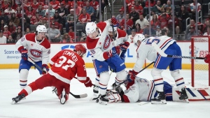 Detroit Red Wings left wing J.T. Compher (37) shoots on Montreal Canadiens goaltender Sam Montembeault (35) in the second period of an NHL hockey game Monday, April 15, 2024, in Detroit. (AP Photo/Paul Sancya)
