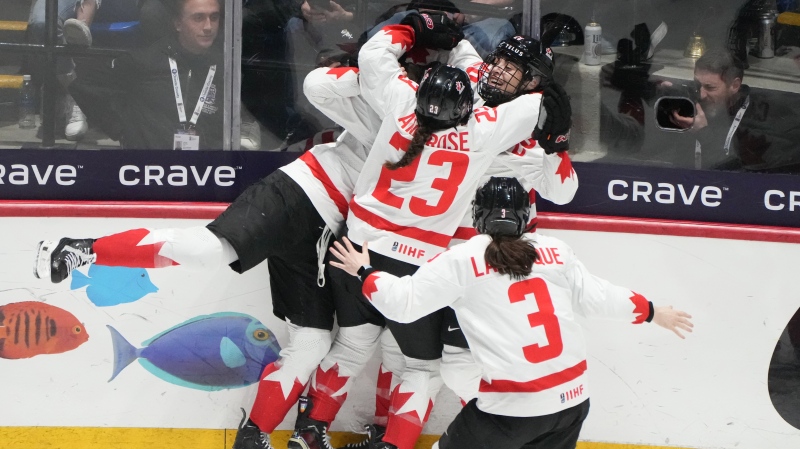 Canada's Danielle Serdachny (92) celebrates her overtime goal over the United States with teammates in their gold medal game at the IIHF Women's World Hockey Championship in Utica, N.Y., Sunday, April 14, 2024. THE CANADIAN PRESS/Christinne Muschi