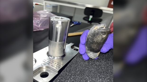 This undated photo provided by NASA shows a recovered chunk of space junk from equipment discarded at the International Space Station. (NASA via AP)
