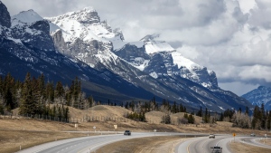 Traffic travels along the Trans Canada Highway past Mount Rundle of the Rocky Mountains near Canmore, Alta., Monday, April 24, 2023.THE CANADIAN PRESS/Jeff McIntosh