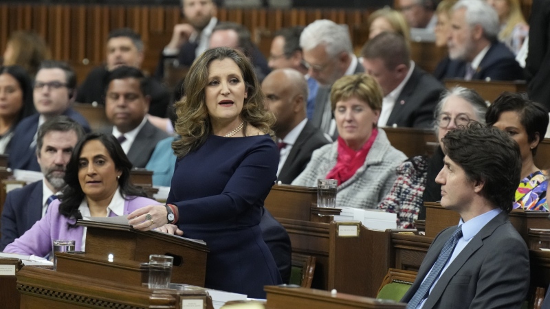 Deputy Prime Minister and Minister of Finance Chrystia Freeland rises to present the federal budget in the House of Commons in Ottawa as Prime Minister Justin Trudeau, lower right, listens on Tuesday, April 16, 2024. (THE CANADIAN PRESS/Adrian Wyld)