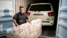 CBSA Superintendent Jean-Francois Rainville removes a mattress that was used to hide a stolen Toyota Sequoia in a container at a news conference Thursday, July 17, 2014 in Montreal. THE CANADIAN PRESS/Ryan Remiorz
