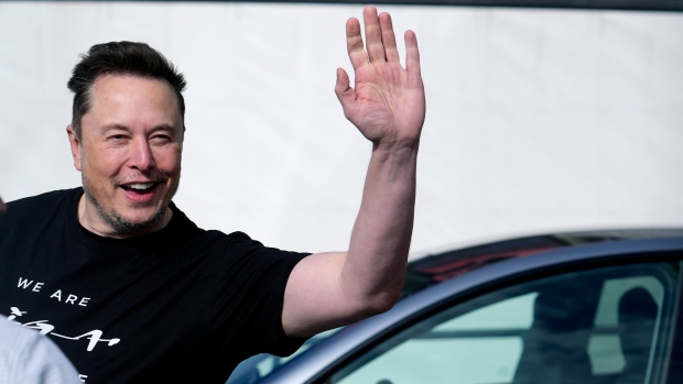 Tesla CEO Elon Musk waves as he leaves the Tesla Gigafactory for electric cars after a visit in Gruenheide near Berlin, Germany, Wednesday, March 13, 2024. (AP Photo/Ebrahim Noroozi) 