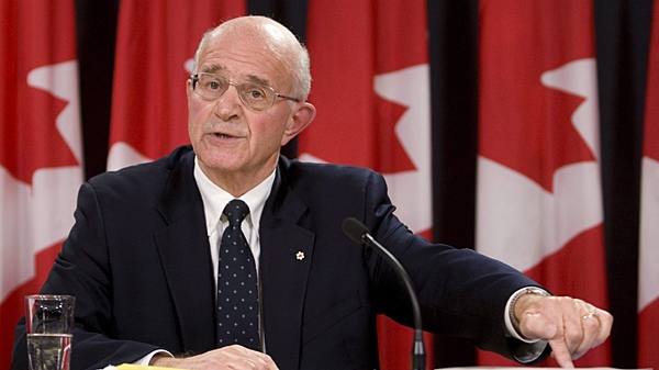 Retired Supreme Court justice Frank Iacobucci points to a copy of the Internal Inquiry Report into the Actions of Canadian Officials in Relation to Abdullah Almalki, Ahmad Abou-Elmaati and Muayyed Nureddin as he responds to a question following its release in Ottawa Tuesday Oct.21, 2008. (Adrian Wyld / THE CANADIAN PRESS)