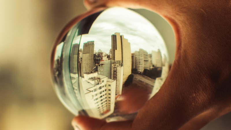 A person holds a crystal ball. (Bia Sousa/pexels.com)