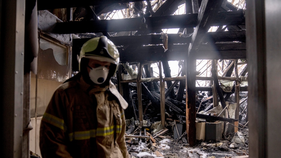 A firefighter examines the damage