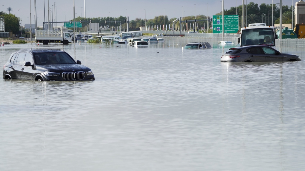 Vehicles sit abandoned in floodwater