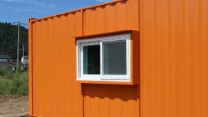 A shipping container with a window in it is shown in this stock photo. (Image credit: Shutterstock) 