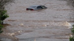 An abandoned car in a mall parking lot is seen in floodwater following a major rain event in Halifax on Saturday, July 22, 2023. THE CANADIAN PRESS/Darren Calabrese