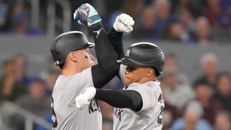 New York Yankees' Juan Soto, right, celebrates with teammate Aaron Judge after scoring a solo home run during ninth inning American League MLB baseball action against Toronto Blue Jays in Toronto on Wednesday April 17 2024. THE CANADIAN PRESS/Chris Young